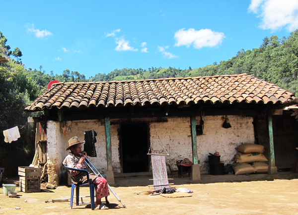 Guatemalan man enjoying the sunshine outside his house in the country