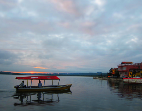 An early morning boat pulls into Flores, Guatemala